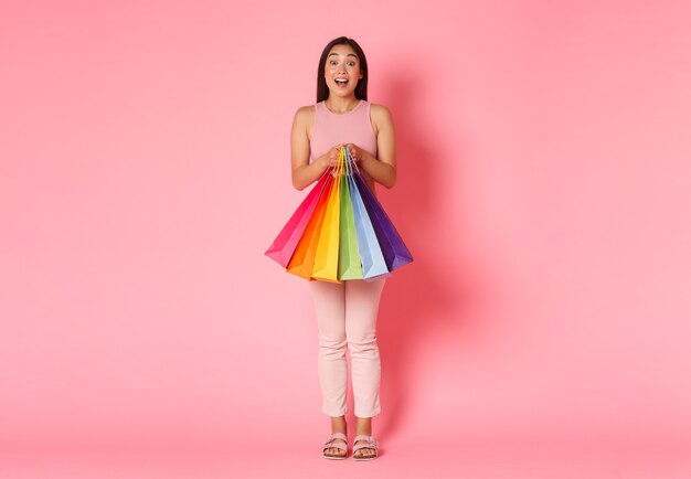 Portrait expressive young woman with shopping bags