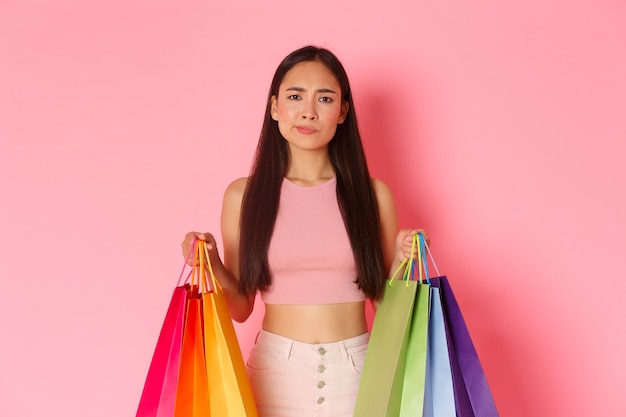 Free photo portrait expressive young woman with shopping bags