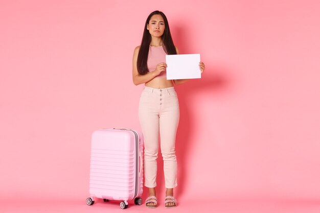 Portrait expressive young woman with suitcase