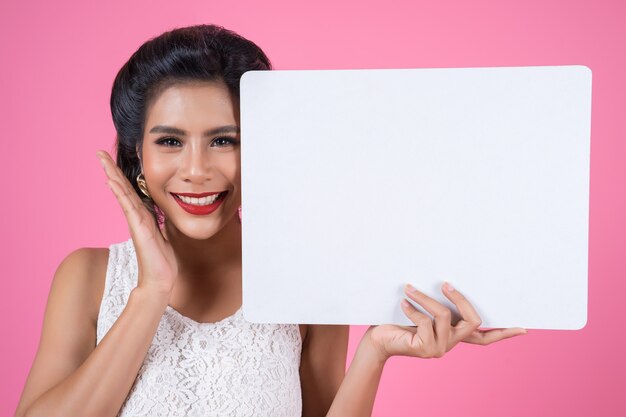 Portrait of fashion woman displaying white banner
