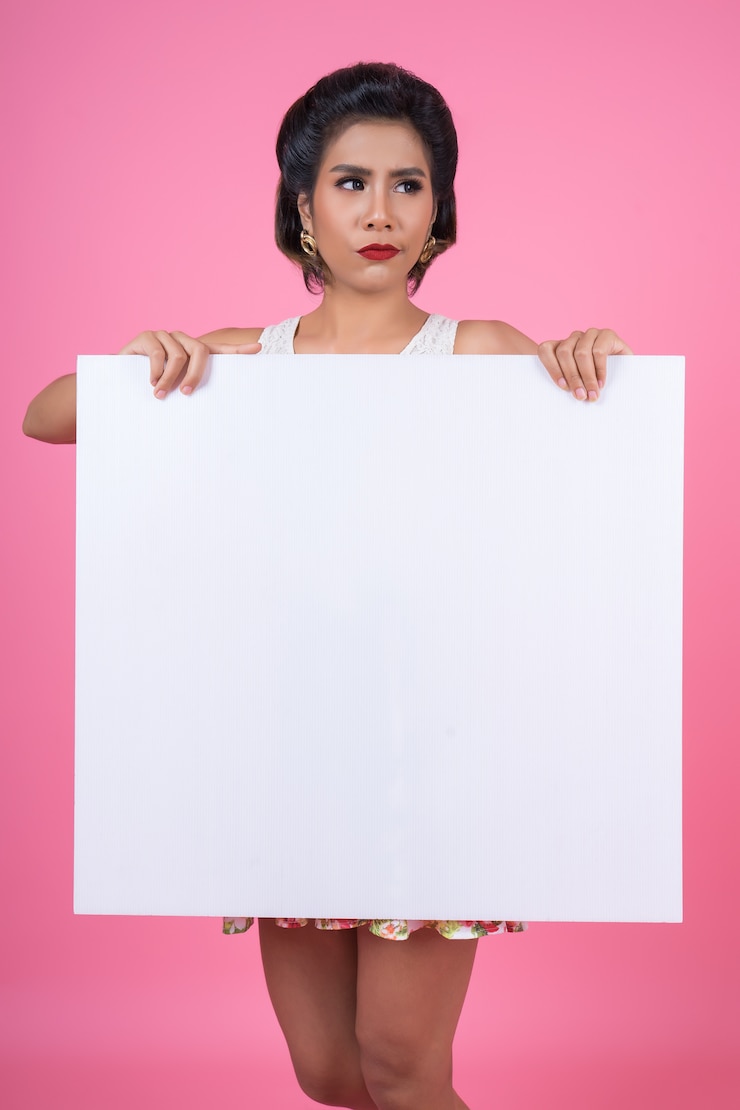 Free Photo portrait of fashion woman displaying white banner
