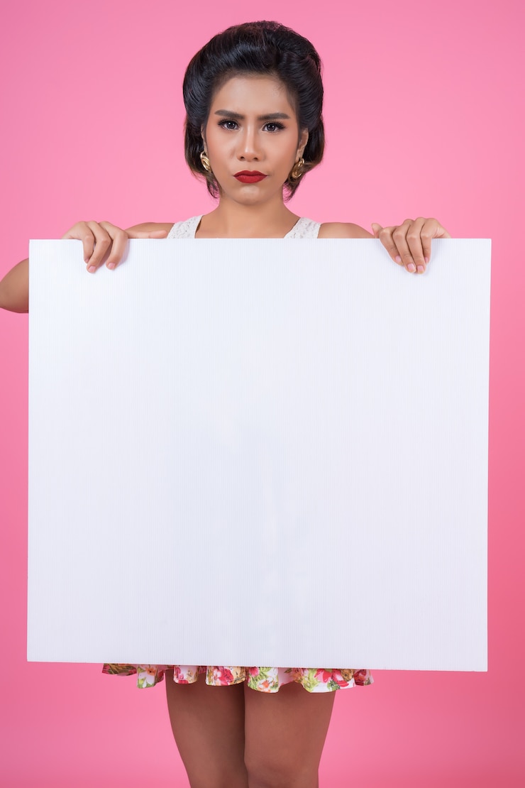 Free Photo portrait of fashion woman displaying white banner