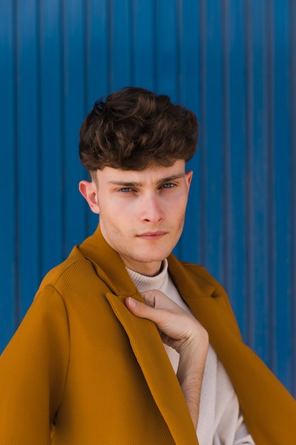 Free Photo | Portrait of fashionable boy against blue wall