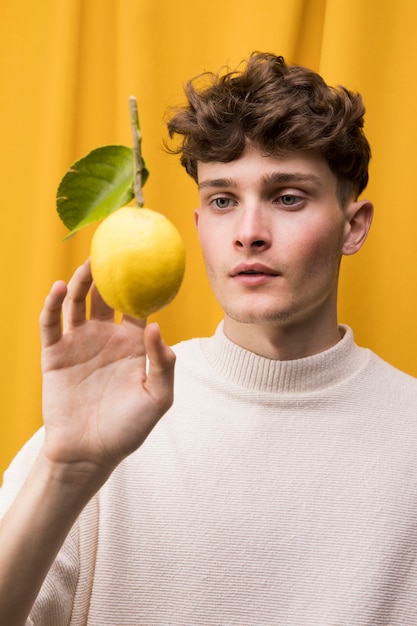 Free photo portrait of fashionable boy with lemon