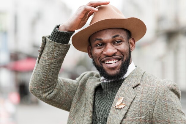 Portrait of fashionable man smiling outdoors