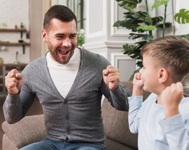 Portrait of father playing with son