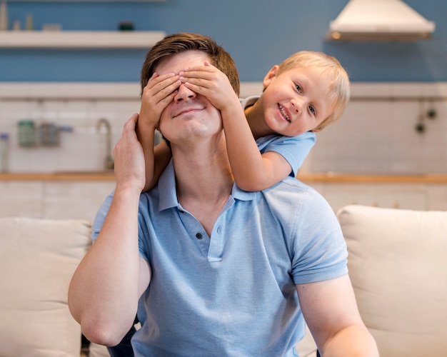 Portrait of father playing with young boy