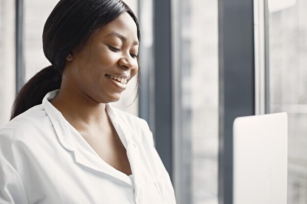 Portrait of female black doctor standing in her office at clinic