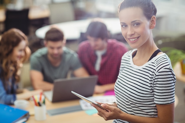 Portrait of female business executive using digital tablet