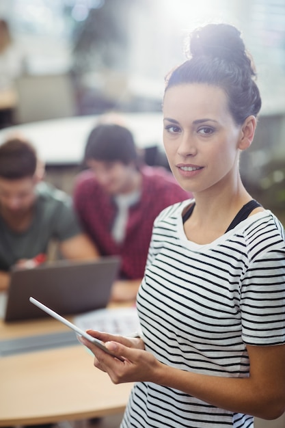 Portrait of female business executive using digital tablet