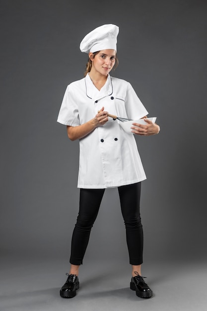 Portrait female chef with bowl mixing