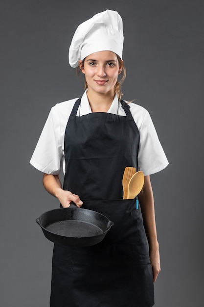 Portrait female chef with pan