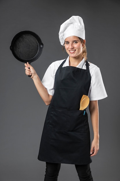 Free photo portrait female chef with pan