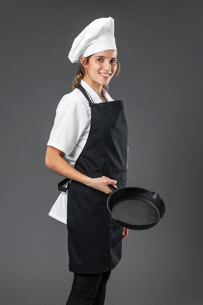 Free photo portrait female chef with pan