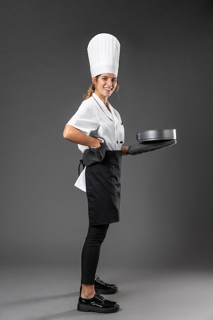 Portrait female chef with pan