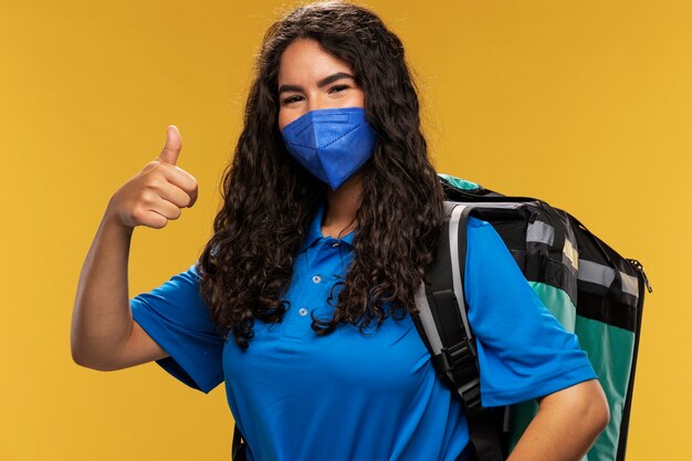 Portrait of female deliverer showing thumbs up