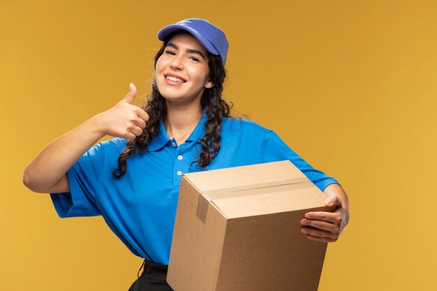 Portrait of female deliverer showing thumbs up