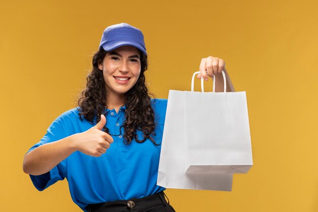 Portrait of female deliverer showing thumbs up