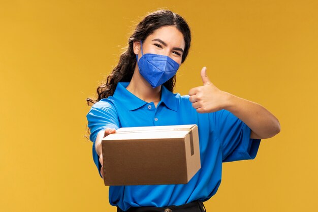 Portrait of female deliverer showing thumbs up