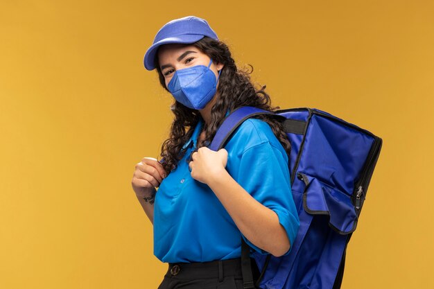 Portrait of female deliverer with backpack