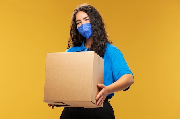 Portrait of female deliverer with medical mask on