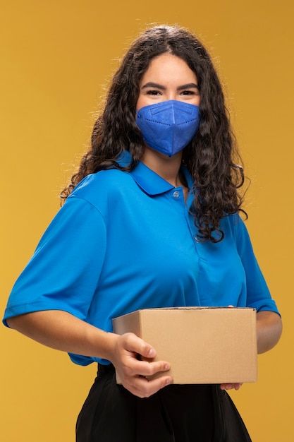 Portrait of female deliverer with medical mask on