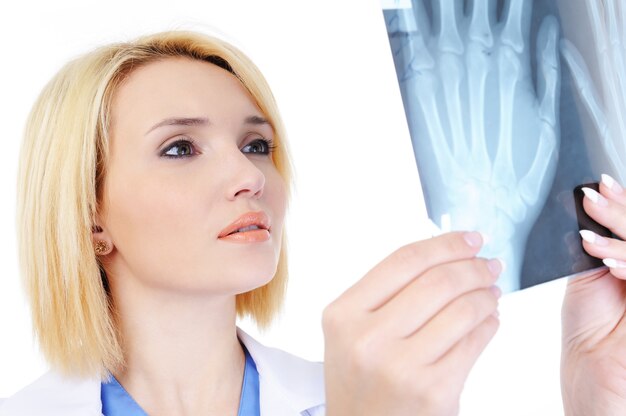 Portrait of Female doctor showing the medical x-ray - isolated on white