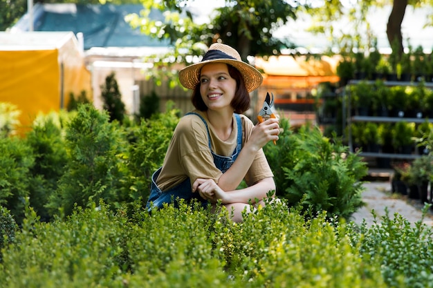 Portrait of female farmer working alone in her greenhouse