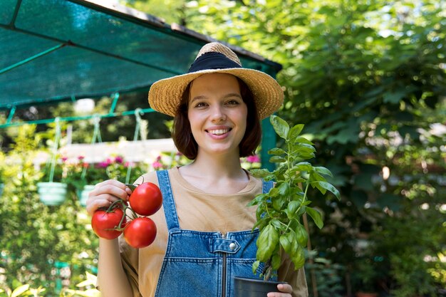 Portrait of female farmer working alone in her greenhouse