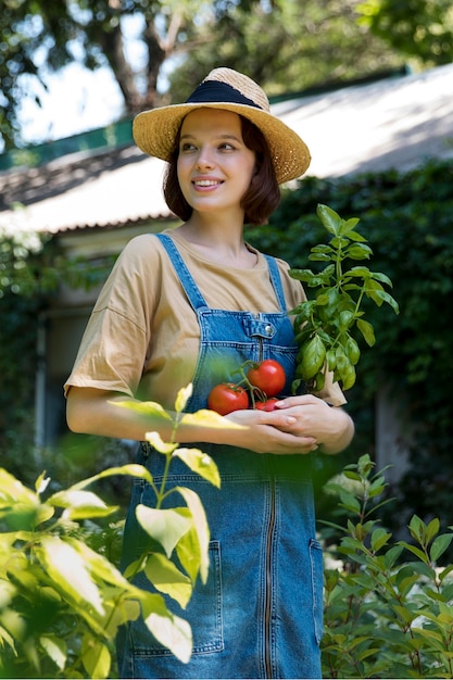 Portrait of female farmer working alone in her greenhouse