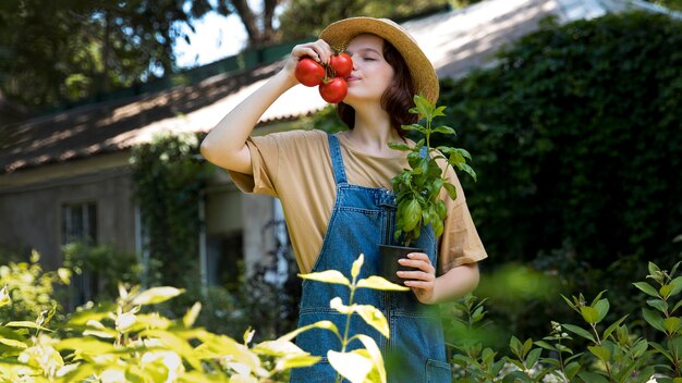 Portrait of female farmer working alone in her greenhouse