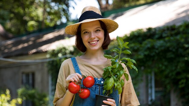portrait of female farmer working alone in her greenhouse