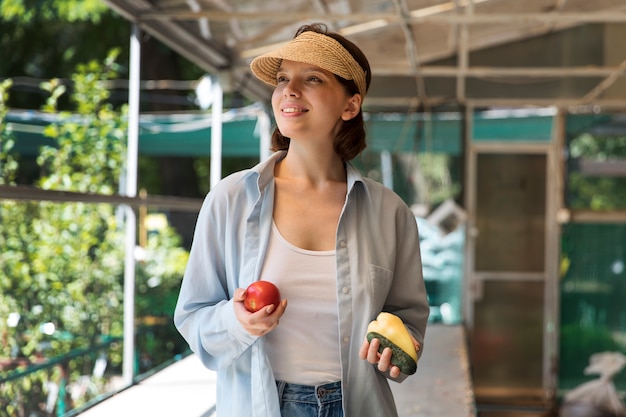 Free photo portrait of female farmer working alone in her greenhouse