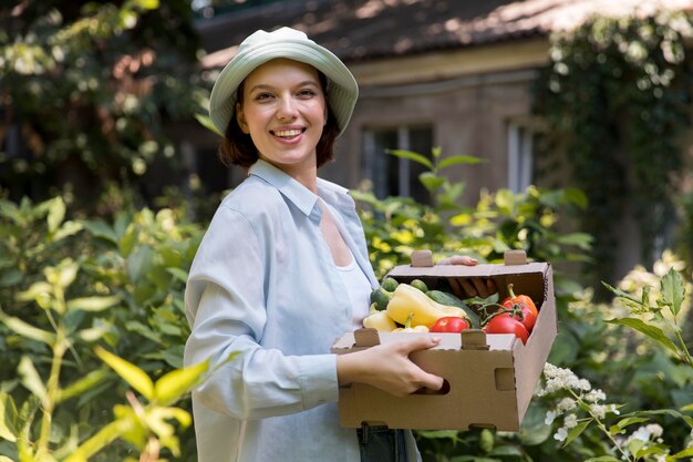 Portrait of female farmer working alone in her greenhouse