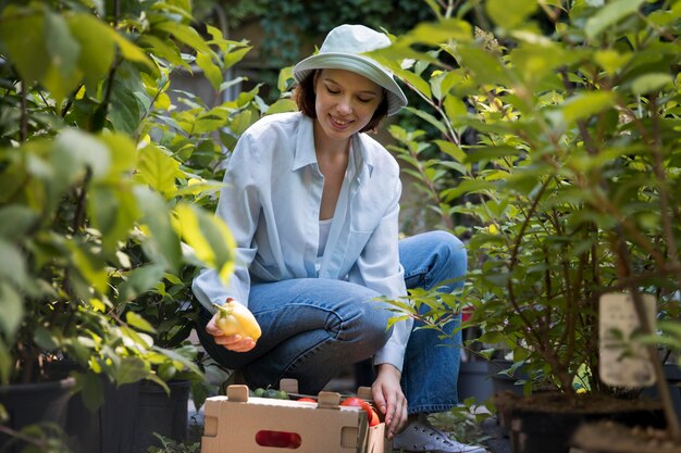 Portrait of female farmer working alone in her greenhouse