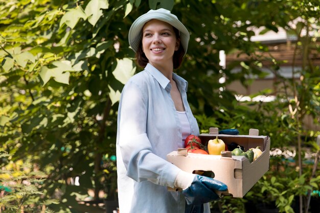 Portrait of female farmer working in her greenhouse