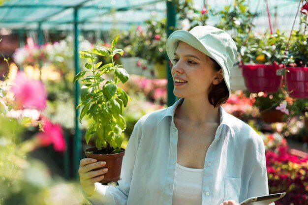 Portrait of female farmer working in her greenhouse