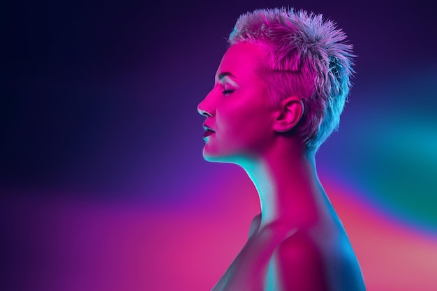 Portrait of female fashion model in neon light