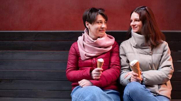 Foto gratuita ritratto di amiche all'aperto con coni gelato