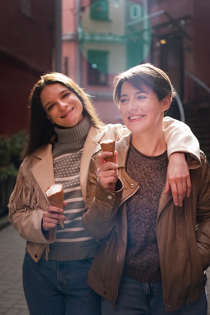 Free Photo portrait of female friends outdoors with ice cream cones