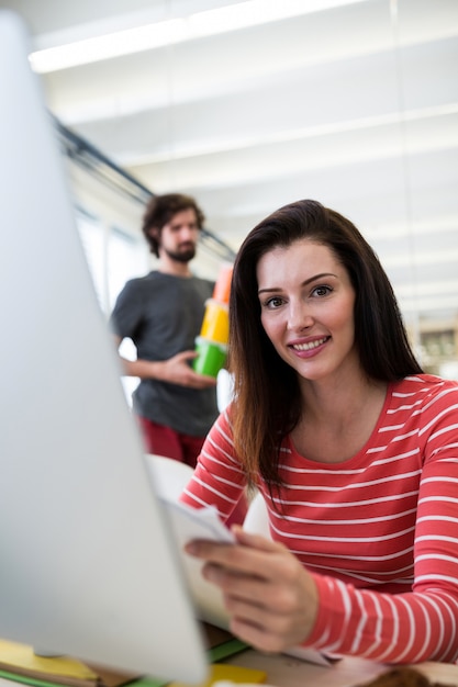 Free photo portrait of female graphic designer holding a document