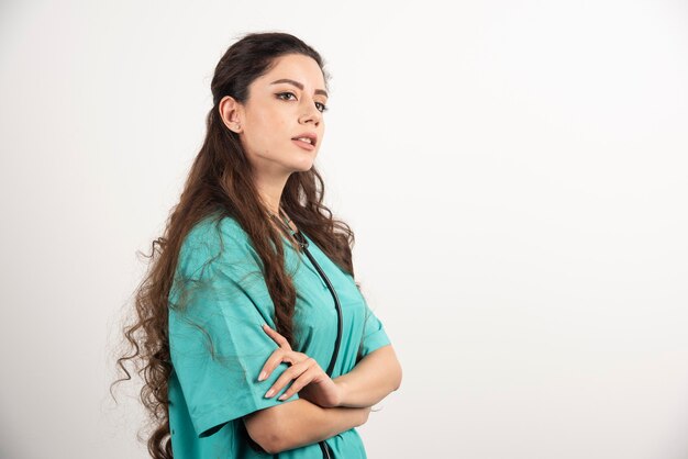 Portrait of female healthcare worker posing with crossed hands.