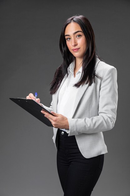 Portrait female lawyer in formal suit with clipboard