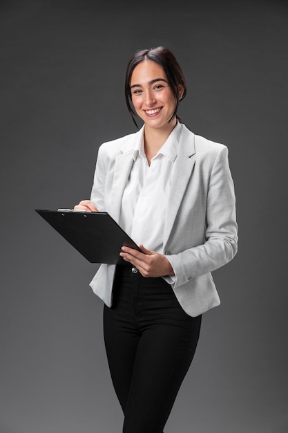 Portrait female lawyer in formal suit with clipboard