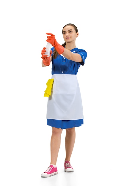 Portrait of female made, housemaid, cleaning worker in white and blue uniform isolated over white