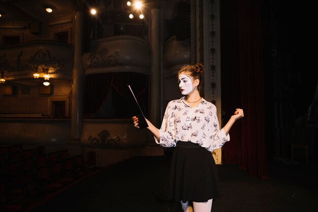 Portrait of female mime rehearsing on stage