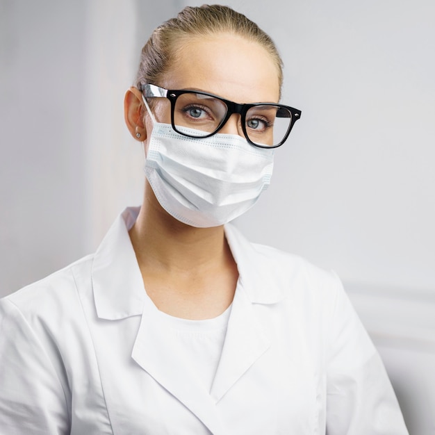 Portrait of female researcher in the lab with medical mask