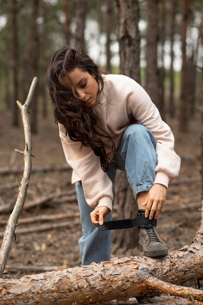 Portrait female tying shoes laces