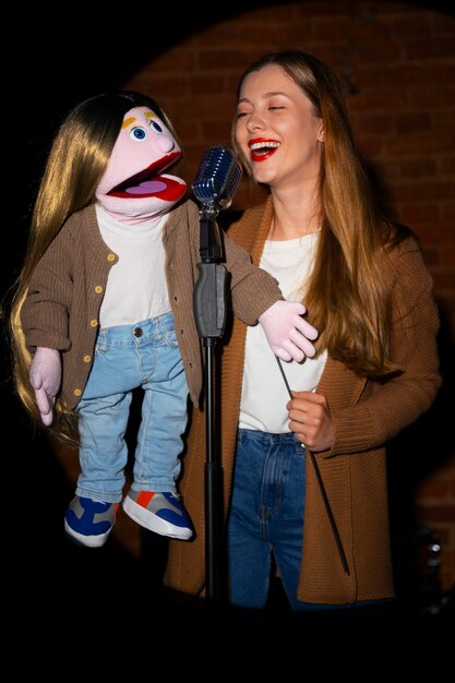 Portrait of female ventriloquist with puppet at show