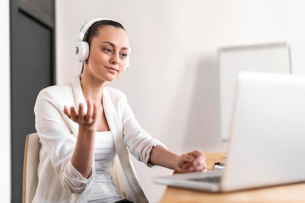 Free photo portrait female at work having video call